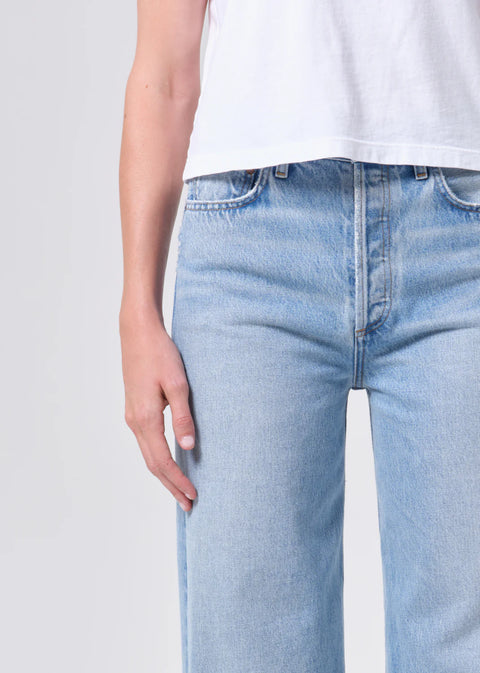 high-rise wide-leg silhouette, high waist, relaxed fit through hips.full-length 32-inch inseam for an elongated, polished look. Worn in light blue indigo wash
