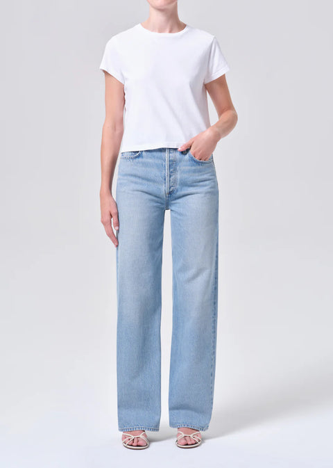 high-rise wide-leg silhouette, high waist, relaxed fit through hips.full-length 32-inch inseam for an elongated, polished look. Worn in light blue indigo wash
