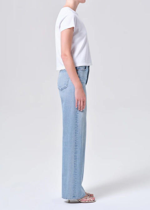 high-rise wide-leg silhouette, high waist, relaxed fit through hips.full-length 32-inch inseam for an elongated, polished look. Worn in light blue indigo wash
