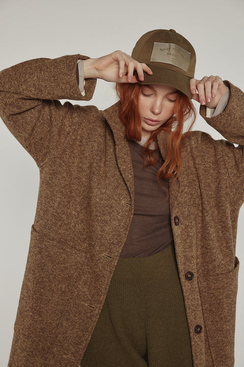 Close-up of Amente herringbone high-neck maxi coat in brown khaki