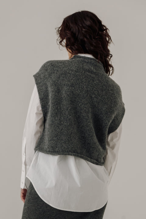 Sweater vest in grey, boxy fit, hits at waist, made of merino wool and has a mock neckline, brand is Bare Knitwear

