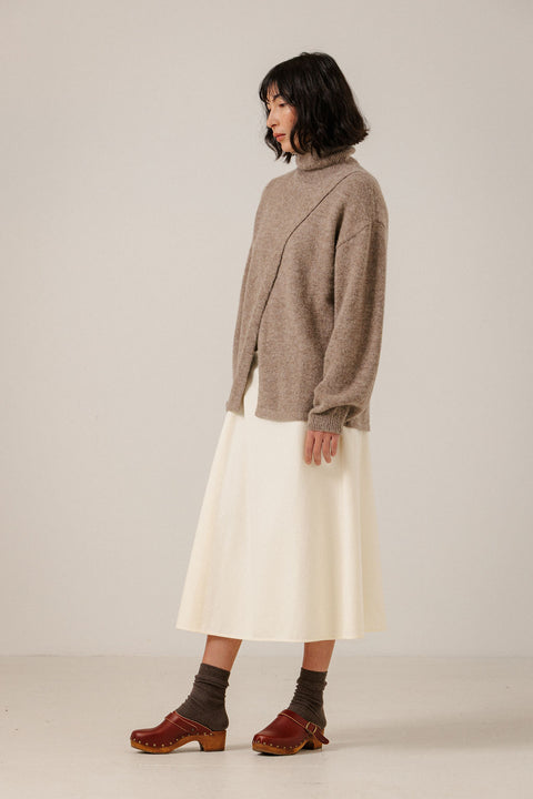 Bare Knitwear Dark Fawn Asymmetric Funnel Neck Sweater - Front View Showing Asymmetric Crossover Detail and Softly Structured Funnel Neckline