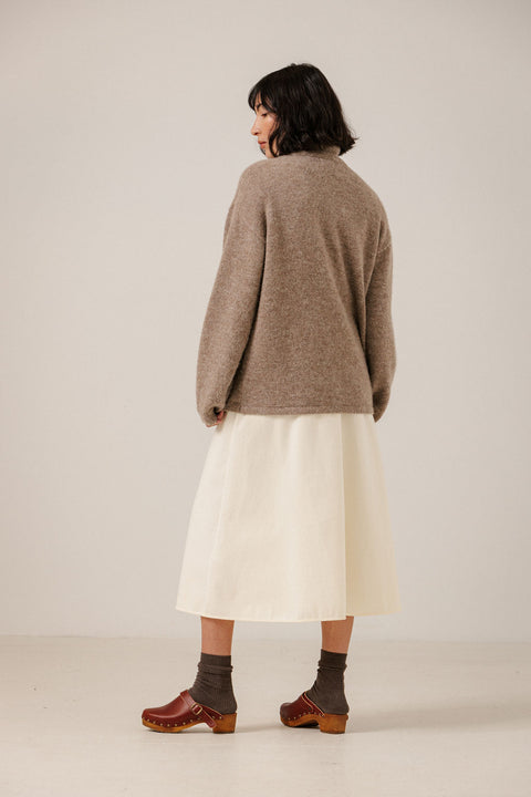 Bare Knitwear Asymmetric Funnel Neck Dark Fawn - Side View Highlighting Layered Crossover Silhouette and Brushed Baby Alpaca Texture