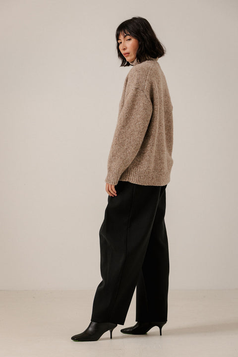 Bare Knitwear Oversized Turtleneck Dark Fawn - Side View Highlighting Easy Oversized Volume and Ribbed Alpaca Texture