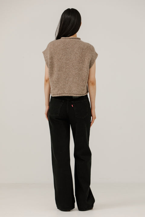 Sweater vest in beige, boxy fit, hits at waist, made of merino wool and has a mock neckline, brand is Bare Knitwear

