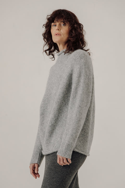 Grey sweater, oversized classic fit, made from alpaca and cotton, seamless rollback neckline, brand is Bare Knit
