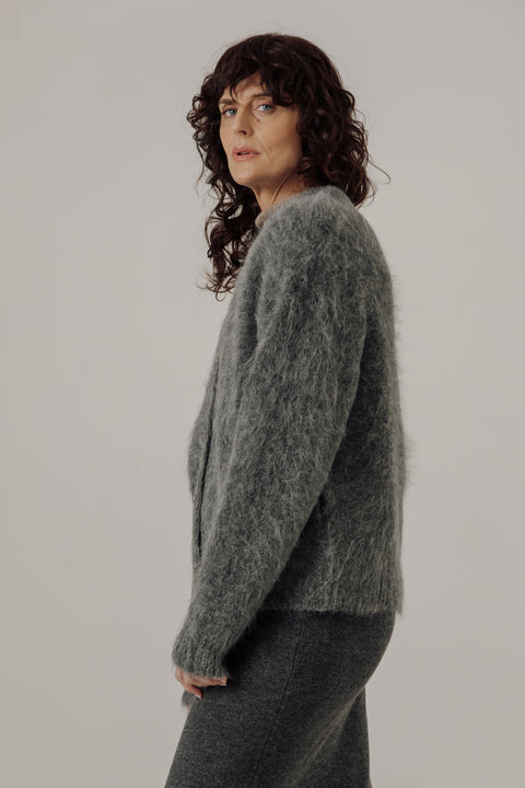V neck cardigan in stone grey, classic boxy fit, light grey buttons. Brand is Bare Knitwear 
