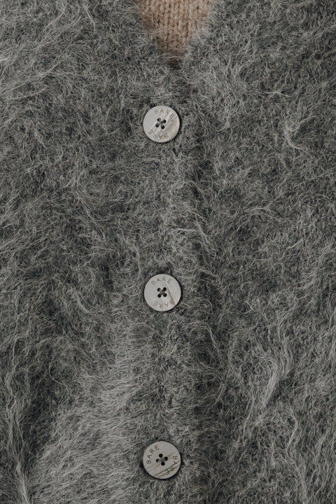 V neck cardigan in stone grey, classic boxy fit, light grey buttons. Brand is Bare Knitwear 
