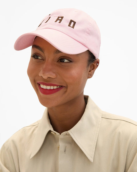 Front view of Clare V light pink baseball cap with chocolate CIAO embroidery – designer embroidered women's hat