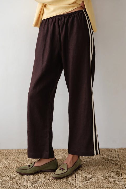 DONNI lightweight linen cropped pants in brown with double white strip down the leg. Elastic waistband and cropped inseam and a wide leg fit. 