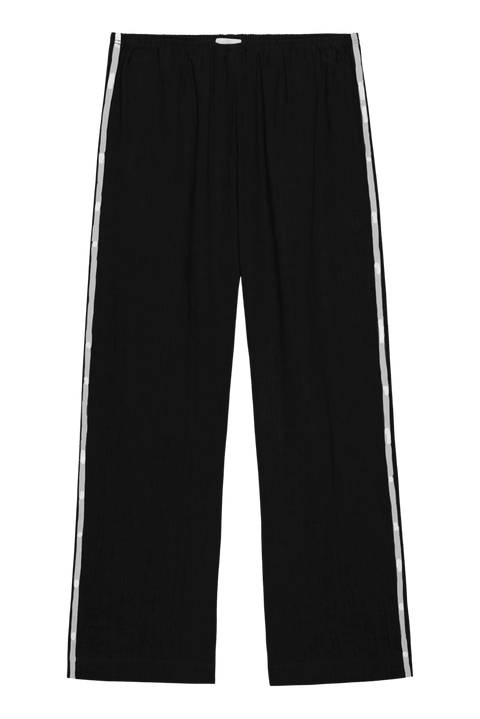 lightweight linen cropped pants in black with double white strip down the leg. Elastic waistband and cropped inseam and a wide leg fit. 
