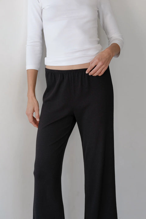 DONNI The Baby Rib Scallop Pant in Jet - Styled Shot Showing Black Knit Pant Paired for Everyday Wear