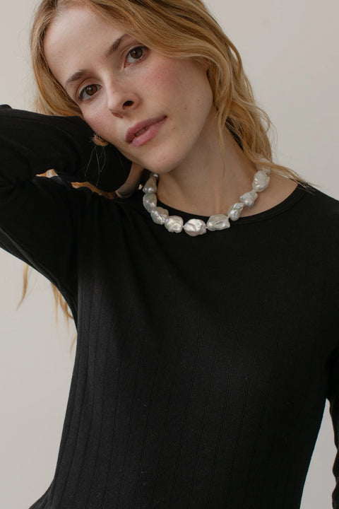 DONNI The Pointelle Long Sleeve in Jet - Styled Shot Showing Black Pointelle Knit Top for Everyday Layering