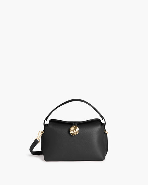 Everyday black leather hand bag, small, can wear it 4 ways, cross body, on wrist, cross body or in your hand. sturdy full-grain leather in Italy, the Hanna features a top handle and adjustable cross-body strap, a magnetic closure with statement gold hardware, and an inner pocket.
