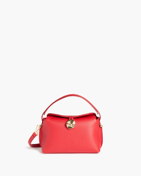 Everyday red leather hand bag, small, can wear it 4 ways, cross body, on wrist, cross body or in your hand. sturdy full-grain leather in Italy, the Hanna features a top handle and adjustable cross-body strap, a magnetic closure with statement gold hardware, and an inner pocket.
