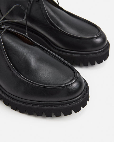 Loafer shoe with a lace up design. Made by flattered. Everyday show for men or women. 