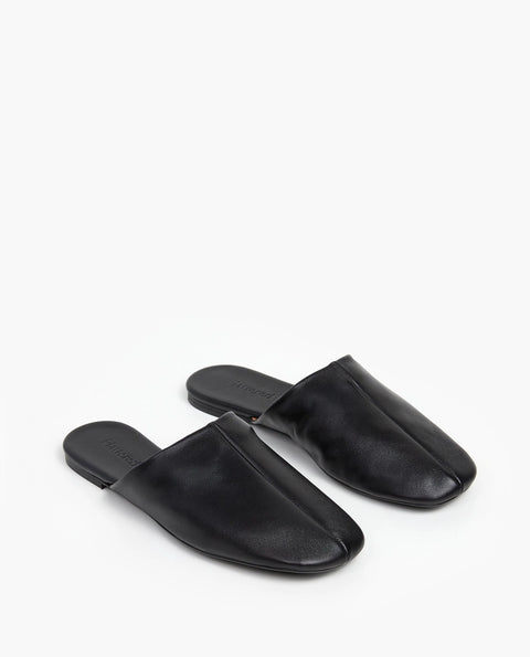 Soft leather black slide, rubber sole, chic slides are bisected with a clean seam through the upper
