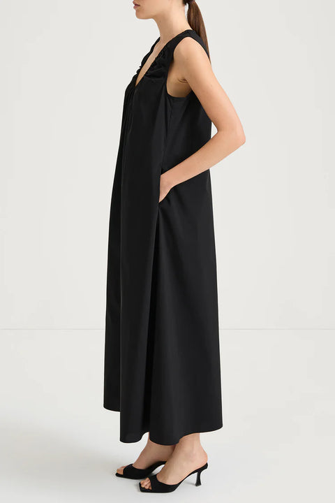 side view of the Jaisie Dress, a soft cotton blend midi dress featuring a U-neckline and gentle gathering for a flowing silhouette.