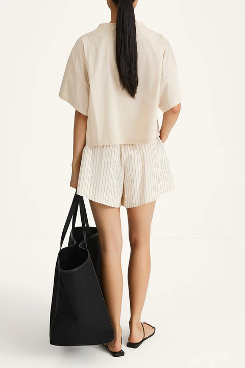 A pair of Jojo shorts in textured poplin featuring a relaxed boxer silhouette with a box pleat, subtle gathering at the waist, and a contemporary flared fit. Back view