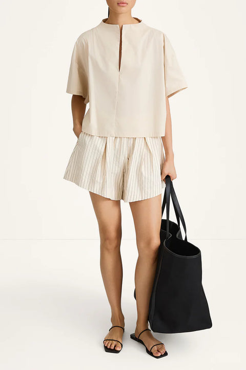 A pair of Jojo shorts in textured poplin featuring a relaxed boxer silhouette with a box pleat, subtle gathering at the waist, and a contemporary flared fit.