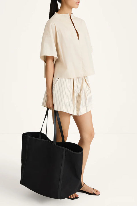 A pair of Jojo shorts in textured poplin featuring a relaxed boxer silhouette with a box pleat, subtle gathering at the waist, and a contemporary flared fit.