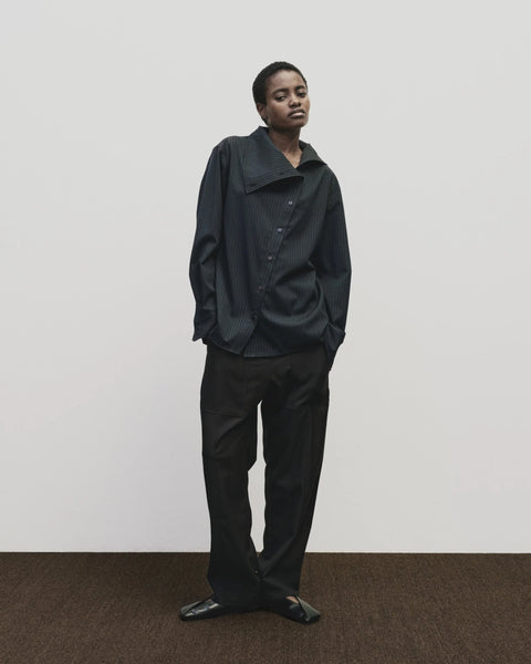 Relaxed fit pants with straight leg and oversized pockets. Buttons on the waist and cuff for adjustability. Navy blue. Trouser by Mijeong Park
