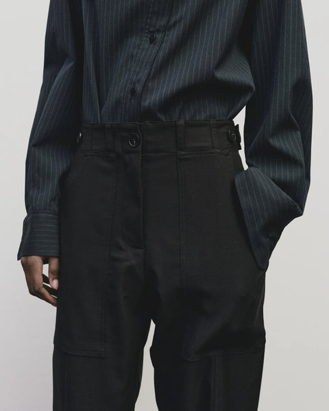 Relaxed fit pants with straight leg and oversized pockets. Buttons on the waist and cuff for adjustability. Navy blue. Trouser by Mijeong Park
