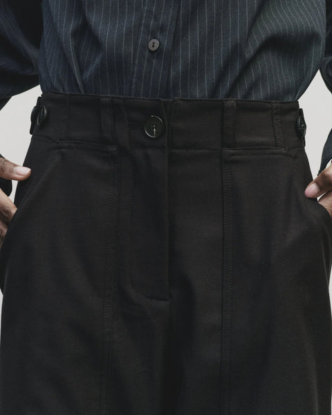 Relaxed fit pants with straight leg and oversized pockets. Buttons on the waist and cuff for adjustability. Navy blue. Trouser by Mijeong Park
