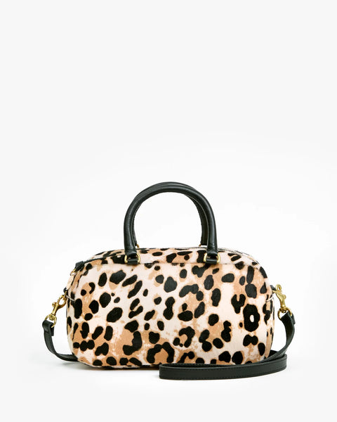Clare V Petite Claudine Snow Leopard Hair-On - styled on model with adjustable strap, 12.75" x 8"