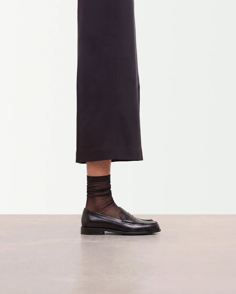 Flattered Sage Black Penny Loafer - Three-Quarter Angle View Showing Classic Loafer Silhouette and Soft Leather Upper