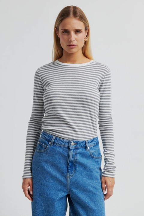 A grey and white striped long sleeve t-shirt by Second Female, featuring a round neckline, twin needle stitching, and a flattering close-fit silhouette crafted from 100% cotton