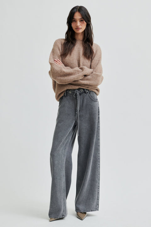 pullover knit, made from alpaca, wool and viscose in beige, crewneck, knotted detail in the back, reversible and had dropped shoulders.  
