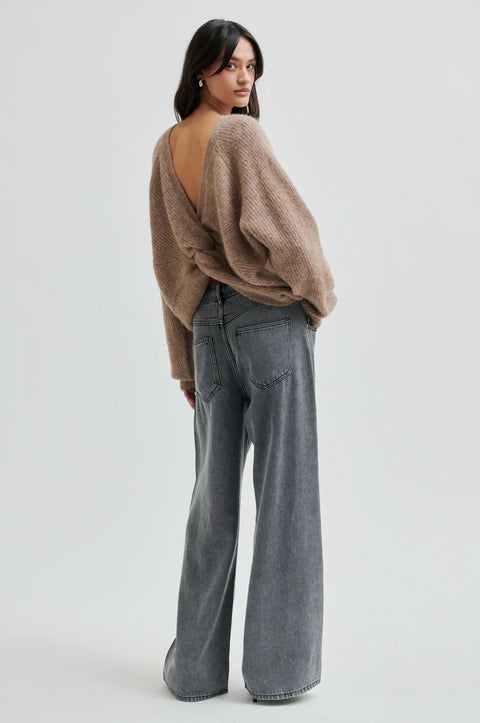 pullover knit, made from alpaca, wool and viscose in beige, crewneck, knotted detail in the back, reversible and had dropped shoulders.  
