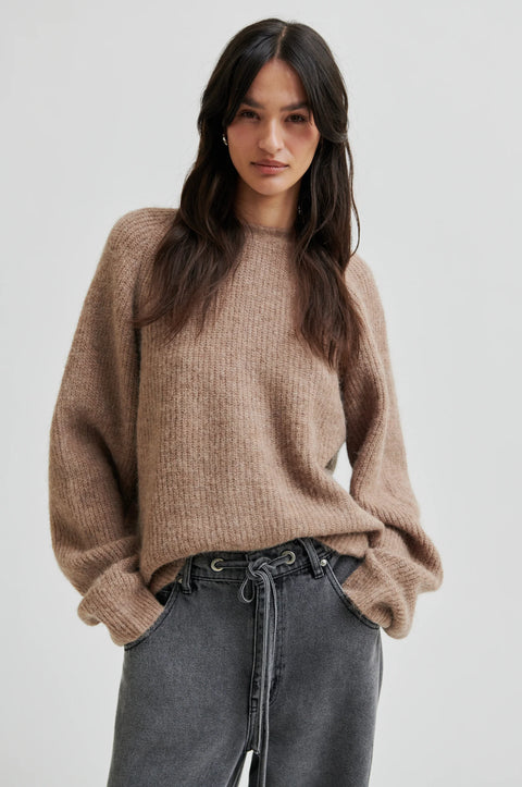 pullover knit, made from alpaca, wool and viscose in beige, crewneck, knotted detail in the back, reversible and had dropped shoulders.  
