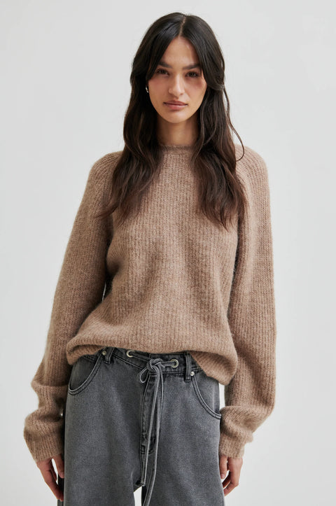 pullover knit, made from alpaca, wool and viscose in beige, crewneck, knotted detail in the back, reversible and had dropped shoulders.  
