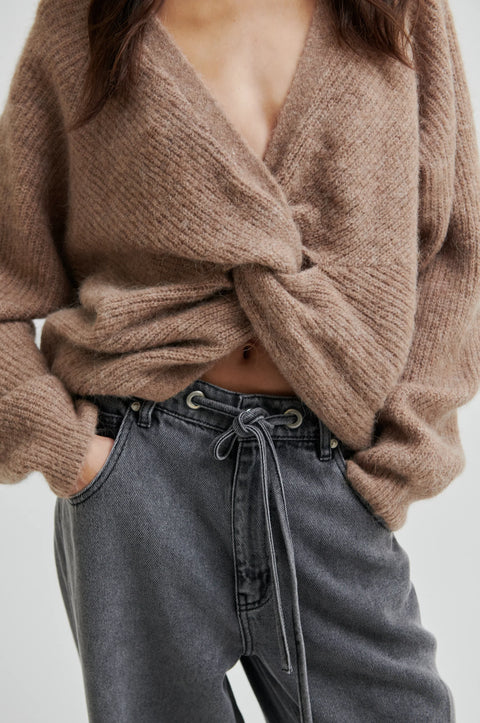 pullover knit, made from alpaca, wool and viscose in beige, crewneck, knotted detail in the back, reversible and had dropped shoulders.  
