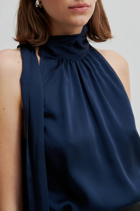 Silky sleeveless blouse in navy blue with the high neck colour with a side tie. Second Female Kura Top 

