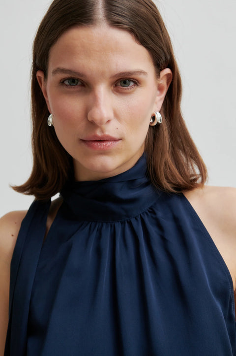 Silky sleeveless blouse in navy blue with the high neck colour with a side tie. Second Female Kura Top 
