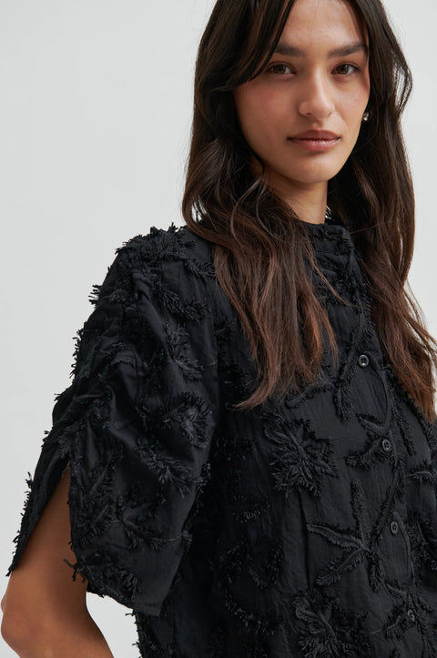 Textured leaf pattern short sleeve cotton sweater in black, button-through placket, and short sleeves with an elastic, ruched detail.
