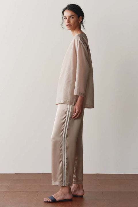 DONNI Silk Crop Pant Shitake Creme - Side View Highlighting Elegant Fluid Charmeuse Drape and Cropped Silhouette