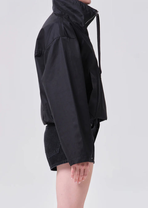 AGOLDE Lydia anorak in black, featuring a three-quarter zip, high collar, and a relaxed cropped fit in breathable lightweight nylon.