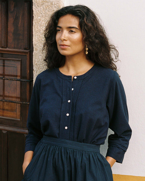 A 100% raw silk Lucia blouse featuring a gathered yoke, refined cuffed sleeves, and a unique handmade button placket for an elevated, minimalist aesthetic.