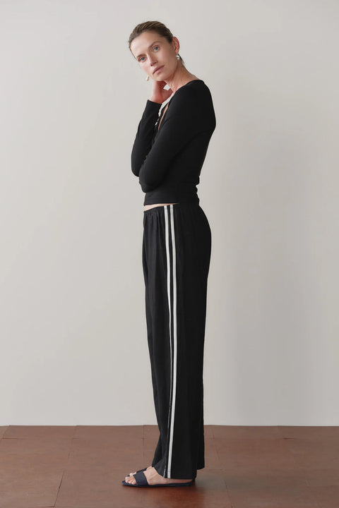 Front view of DONNI jet black linen racer stripe crop pants – summer wide leg trousers in breathable 100% linen