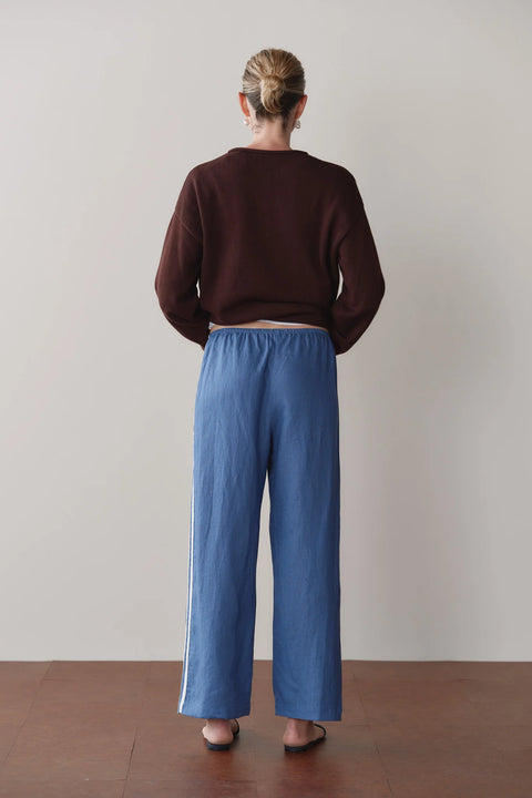 DONNI Linen Crop Pant Lapis Blue - Side View Highlighting Elasticated Waistband and Relaxed Linen Drape