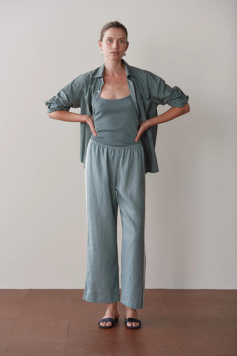 Front view of DONNI sage green linen racer stripe crop pants – summer wide leg trousers in breathable 100% linen